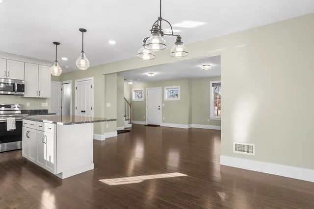 a view of a kitchen with stove and cabinets