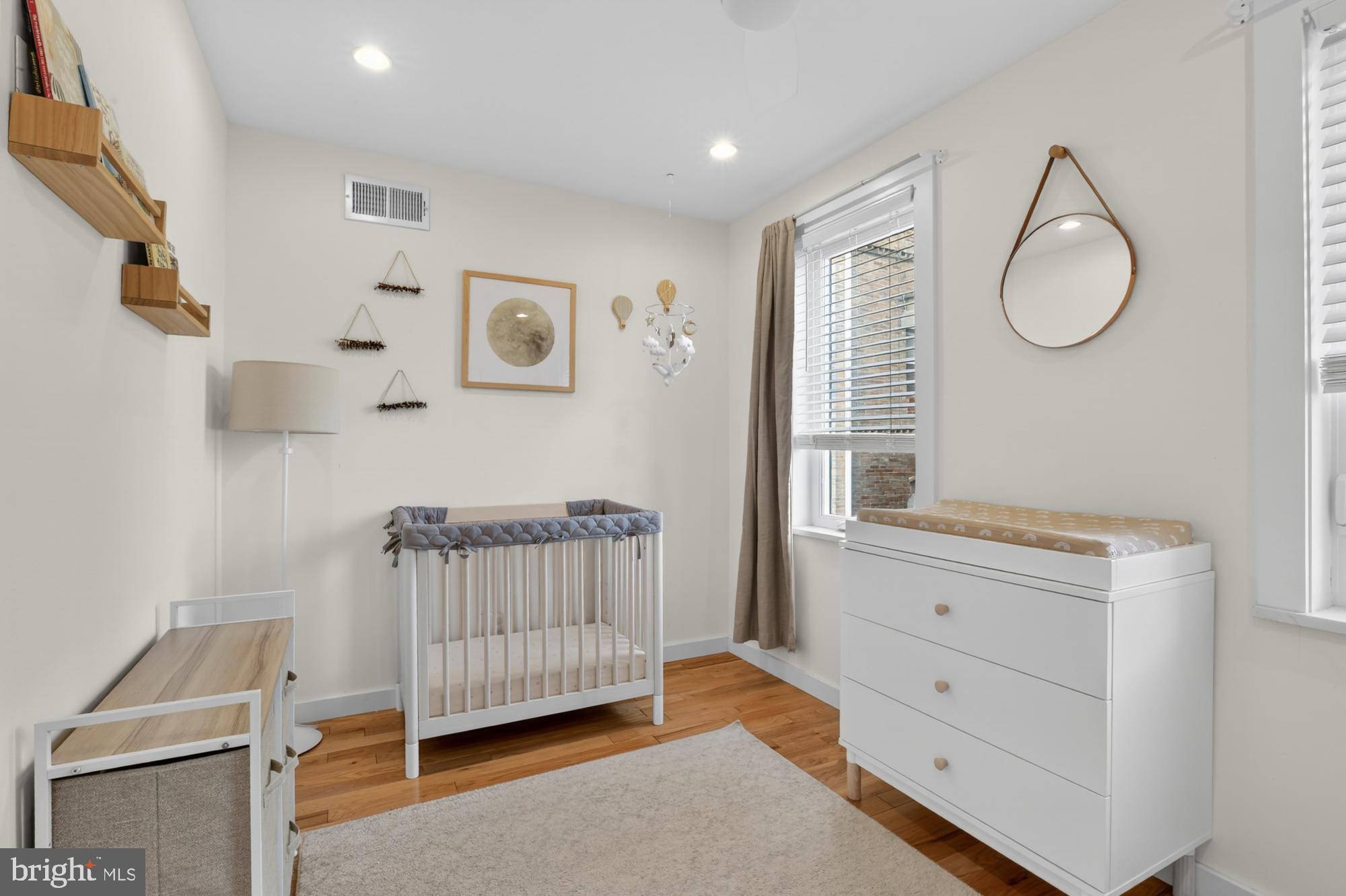 741 Watkins Street Philadelphia, PA 19148 - Photo 14 of 25 a bedroom with a baby bed window and a dresser