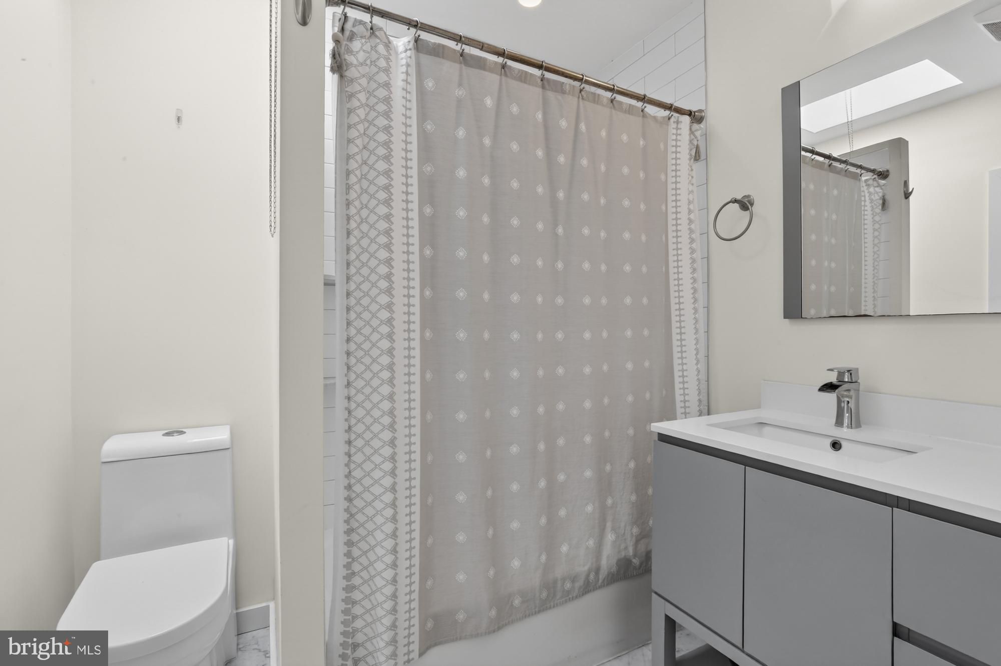 741 Watkins Street Philadelphia, PA 19148 - Photo 18 of 25 a bathroom with a sink a toilet and shower