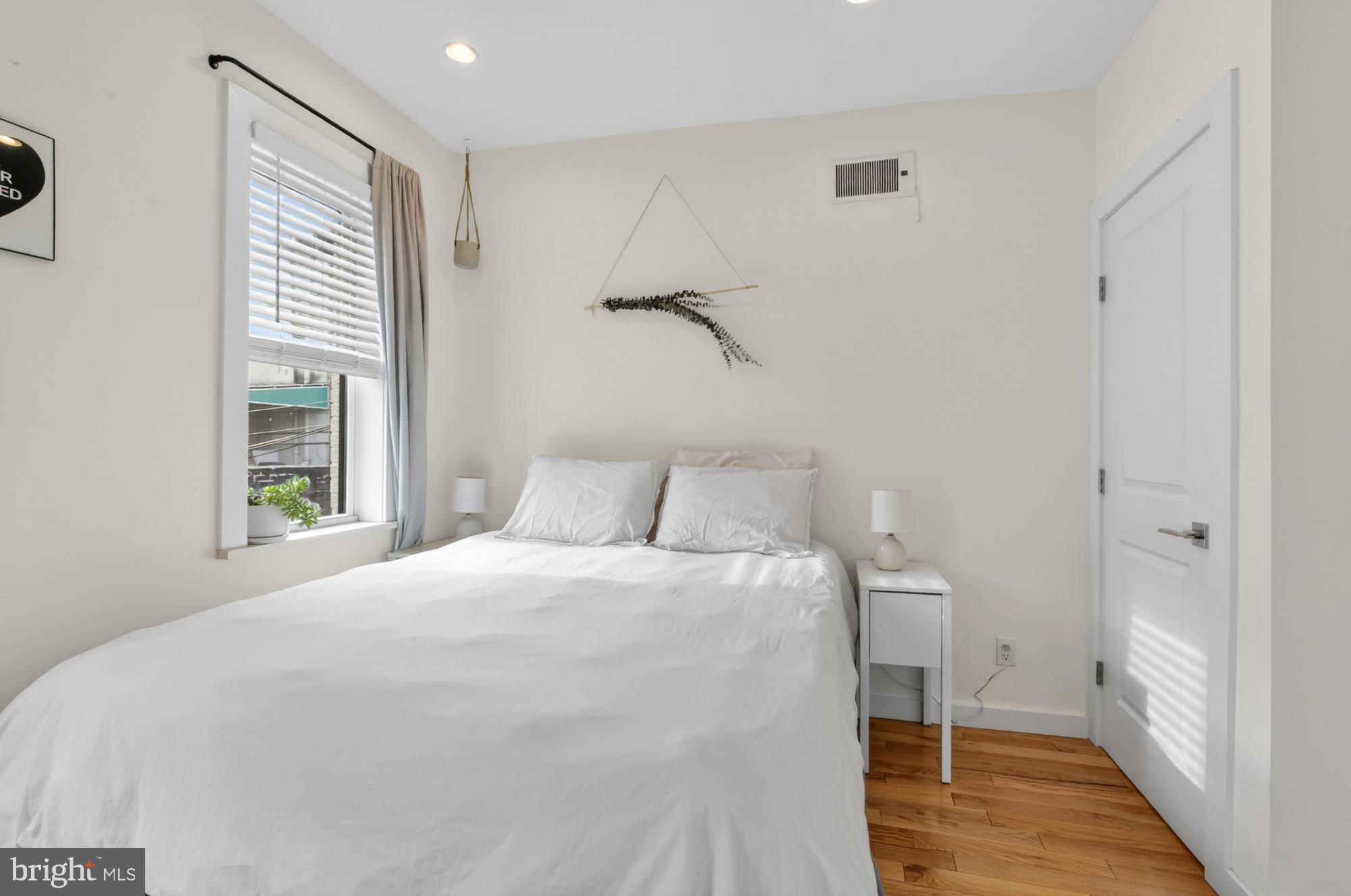 741 Watkins Street Philadelphia, PA 19148 - Photo 21 of 25 a bedroom with a bed and a window