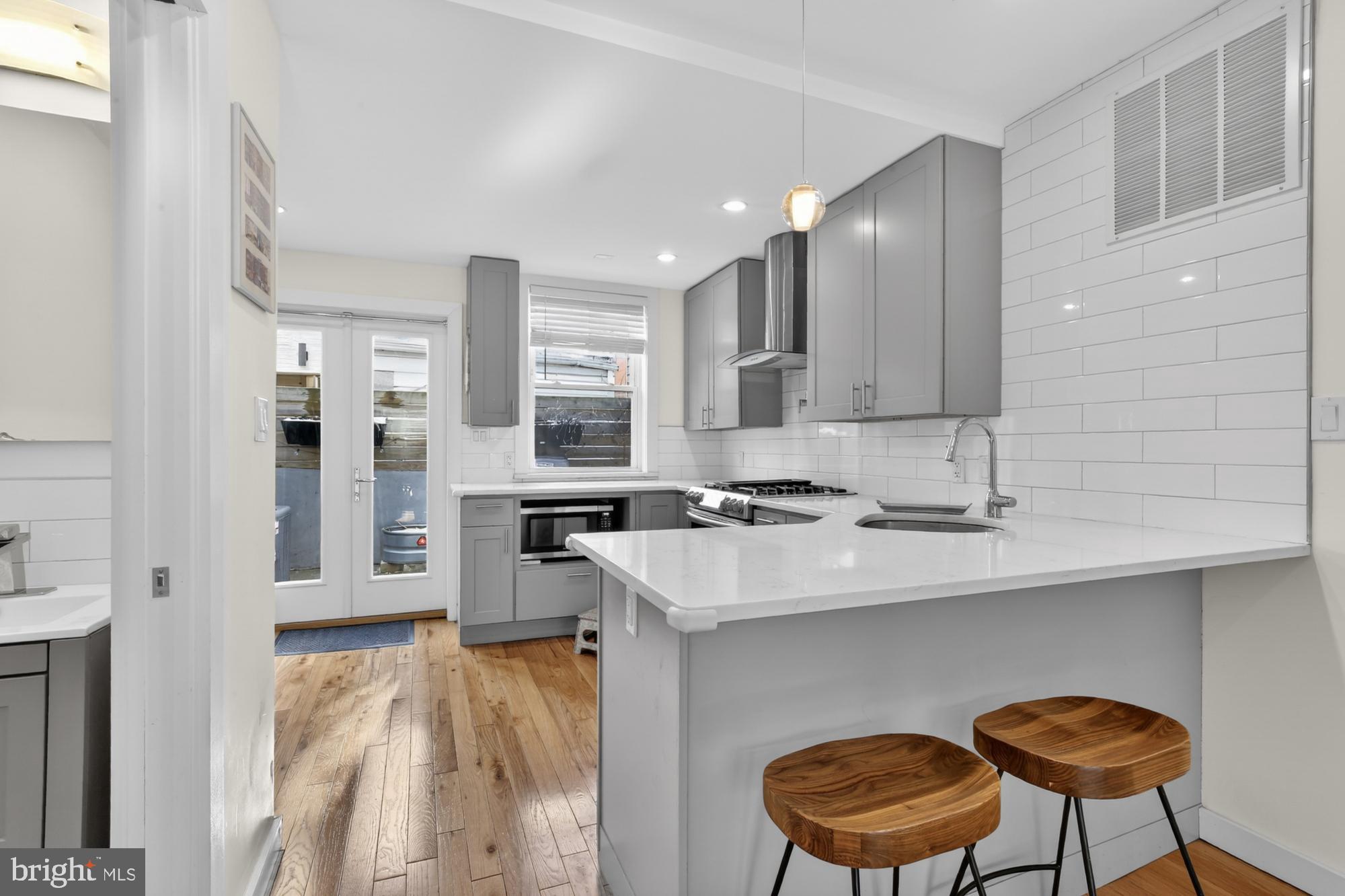 741 Watkins Street Philadelphia, PA 19148 - Photo 6 of 25 a kitchen with stainless steel appliances granite countertop a sink a stove counter space and cabinets