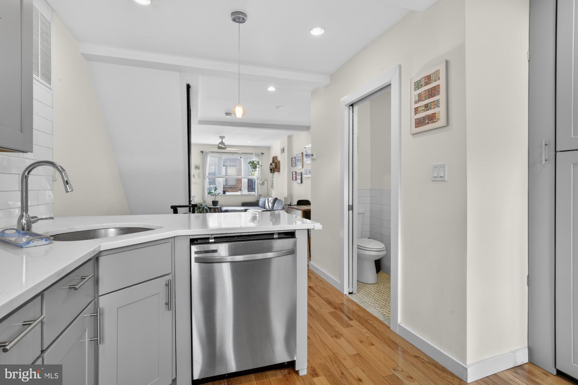 741 Watkins Street Philadelphia, PA 19148 - Photo 8 of 25 a kitchen with a sink and a refrigerator