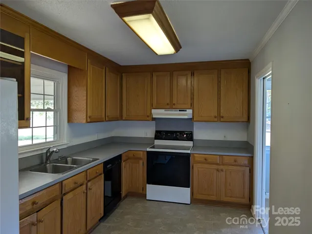 a kitchen with stainless steel appliances granite countertop a refrigerator and a stove