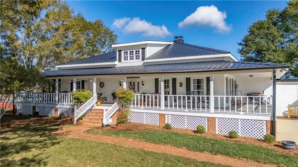 a view of a house with a patio and a yard