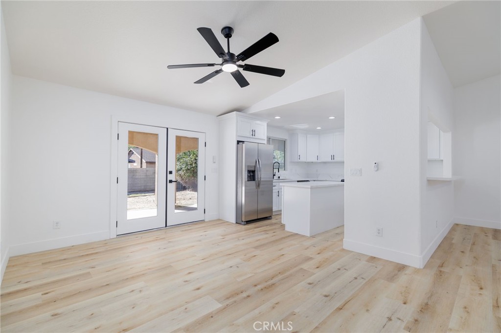 51621 Riza Avenue Cabazon, CA 92230 - Photo 13 of 32 a view of empty room with wooden floor and window