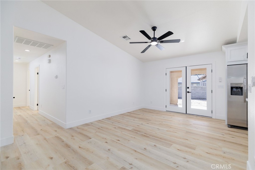 51621 Riza Avenue Cabazon, CA 92230 - Photo 14 of 32 a view of empty room with wooden floor and ceiling fan