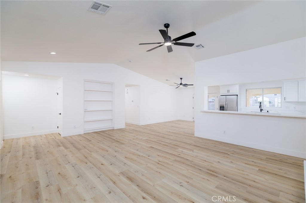 51621 Riza Avenue Cabazon, CA 92230 - Photo 15 of 32 a view of empty room with wooden floor and window