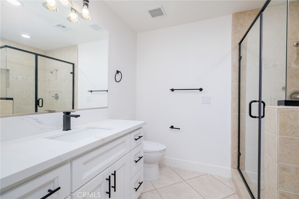 51621 Riza Avenue Cabazon, CA 92230 - Photo 19 of 32 a bathroom with a double vanity sink toilet and shower