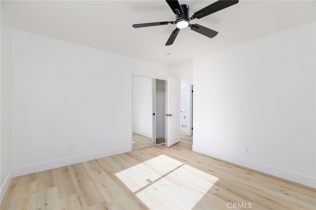 51621 Riza Avenue Cabazon, CA 92230 - Photo 22 of 32 an empty room with ceiling fan and window