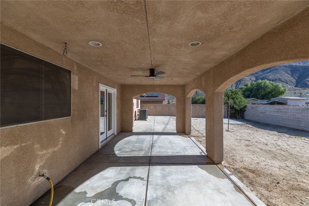 51621 Riza Avenue Cabazon, CA 92230 - Photo 26 of 32 a living room with a couch and a rug