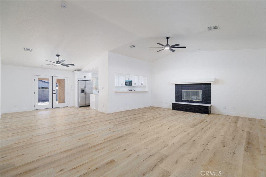 51621 Riza Avenue Cabazon, CA 92230 - Photo 7 of 32 wooden floor in a room with a ceiling fan