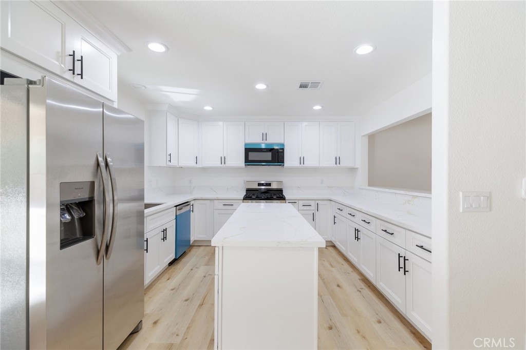 51621 Riza Avenue Cabazon, CA 92230 - Photo 9 of 32 a kitchen with stainless steel appliances cabinets a sink and a stove