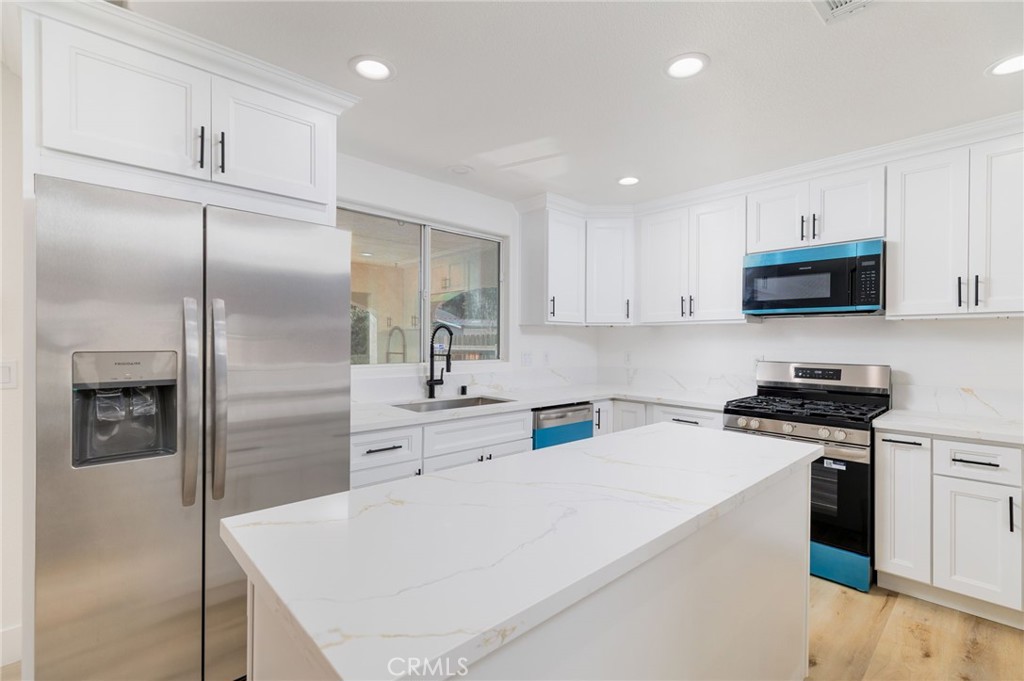 51621 Riza Avenue Cabazon, CA 92230 - Photo 10 of 32 a kitchen with cabinets and stainless steel appliances