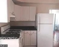 a kitchen with a refrigerator and a stove