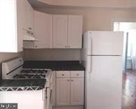 209 Sumac Street Philadelphia, PA 19128 - Photo 6 of 10 a kitchen with a refrigerator and a stove