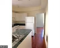 a view of a kitchen from the hallway