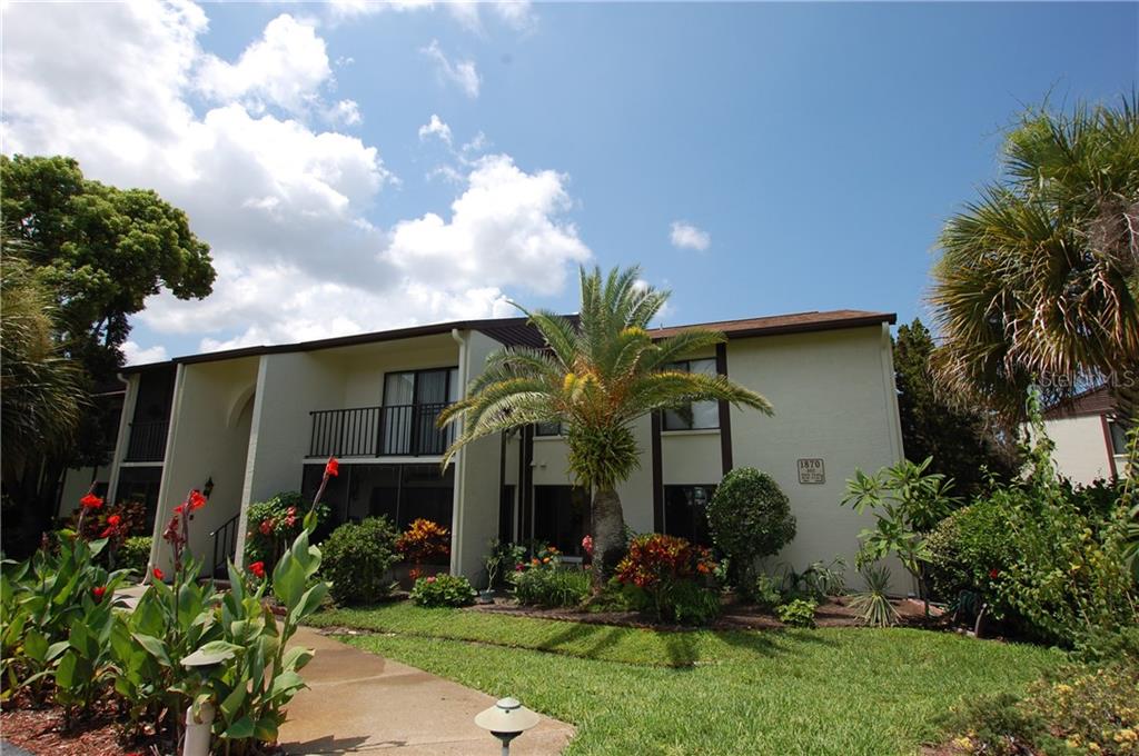 1870 Pine Ridge Way West, Unit A2 Palm Harbor, FL 34684 - Photo 1 of 1 a front view of house with yard