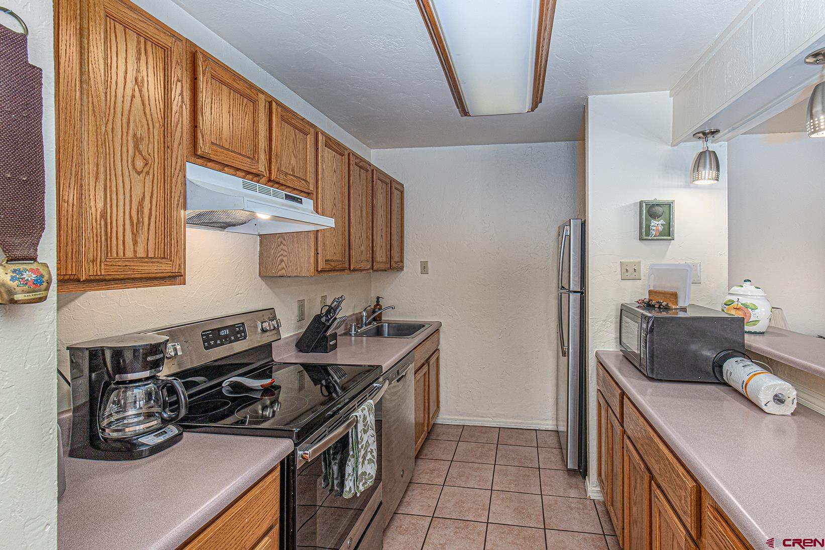 44 Sheol Street, Unit C14 Durango, CO 81301 - Photo 13 of 23 a kitchen with stainless steel appliances granite countertop a stove and a sink
