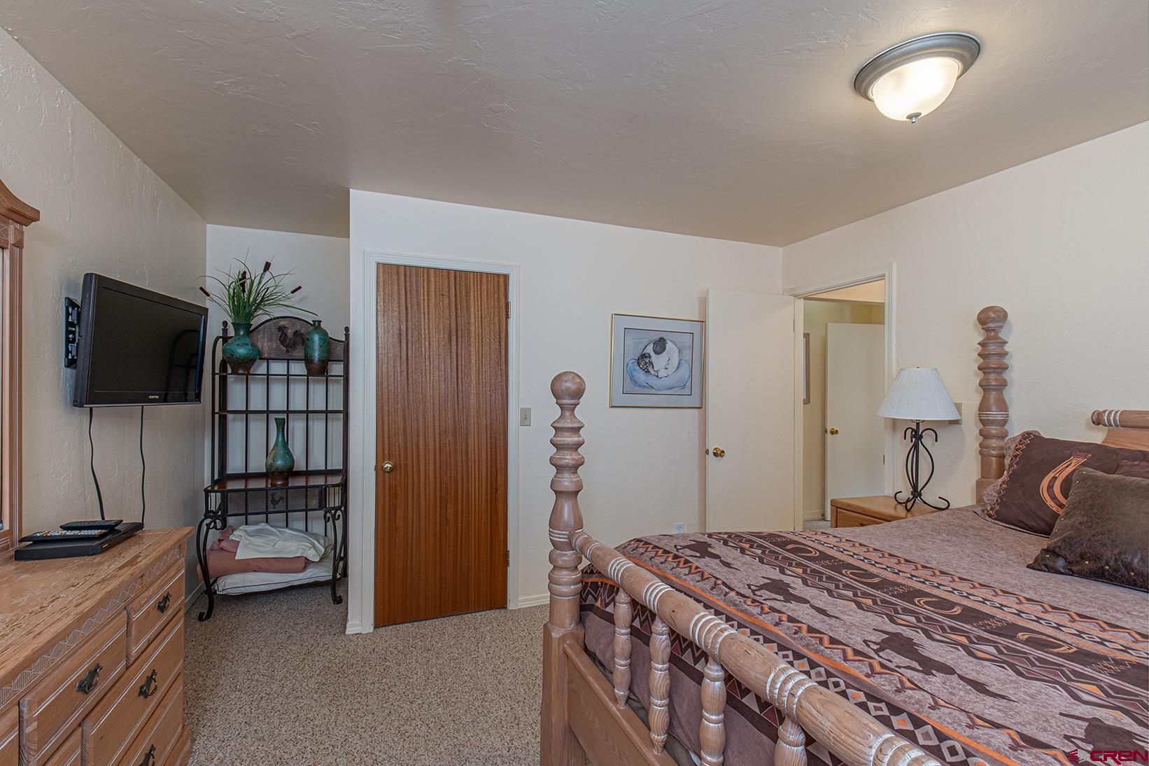 44 Sheol Street, Unit C14 Durango, CO 81301 - Photo 17 of 23 a bedroom with a bed and a flat screen tv