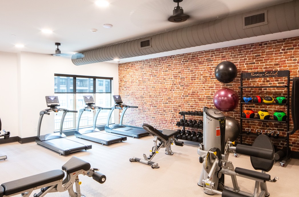 3100 Scofield Ridge Parkway, Unit 2115 Austin, TX 78727 - Photo 17 of 21 Workout area with ceiling fan, brick wall, and visible vents