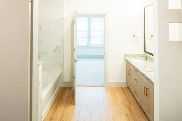 a bathroom with a granite countertop sink a toilet and shower