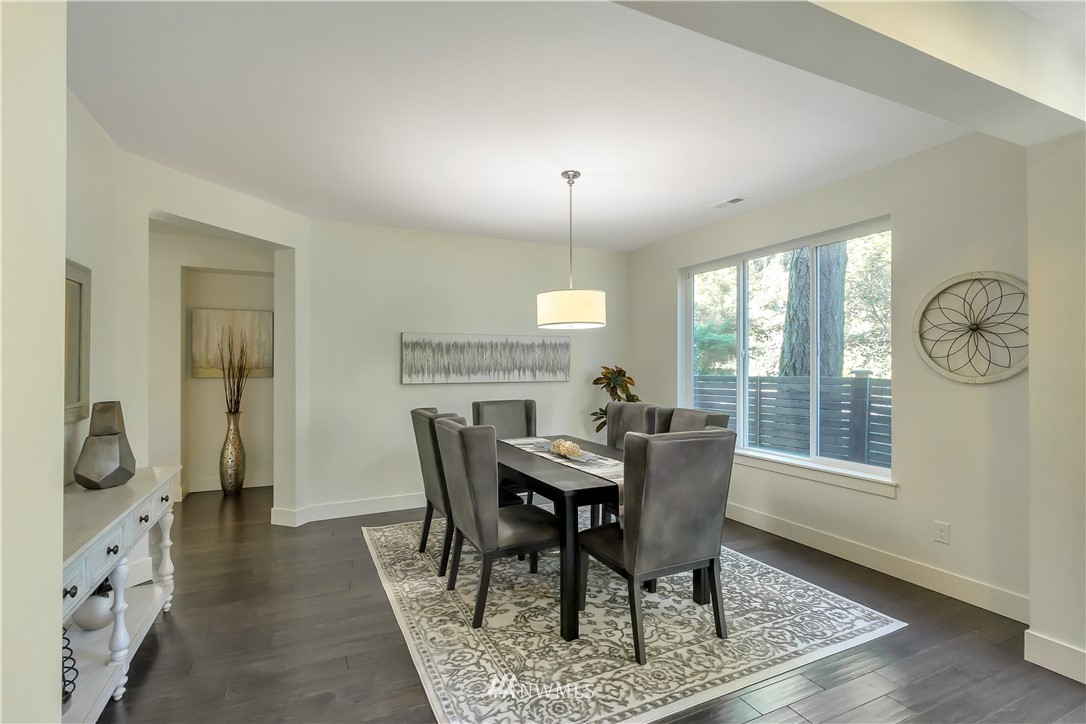 4431 225th Place Southeast Bothell, WA 98021 - Photo 2 of 19 a view of a dining room with furniture window and wooden floor