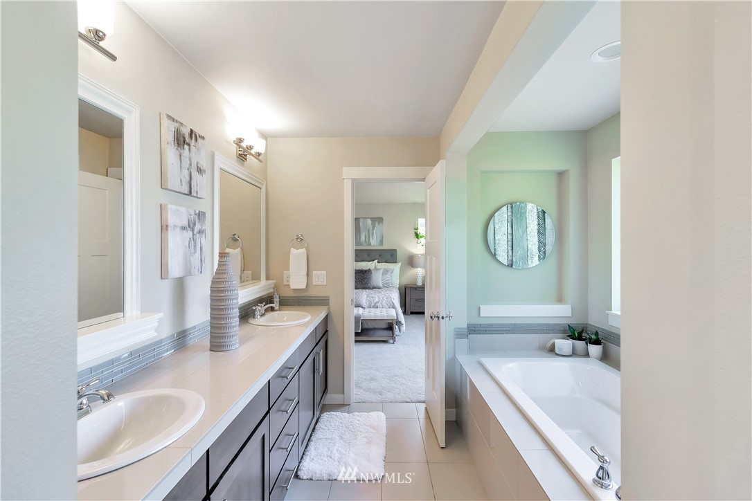 4431 225th Place Southeast Bothell, WA 98021 - Photo 18 of 19 a large bathroom with a granite countertop tub double vanity sink and a large mirror