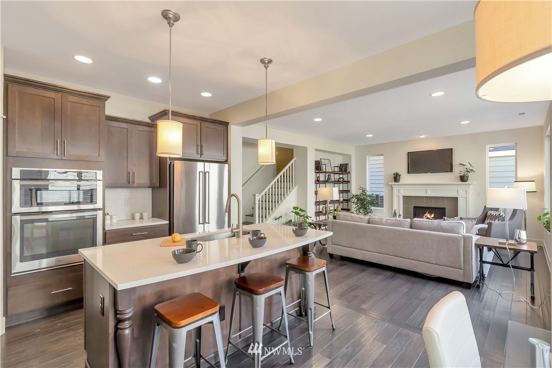 4431 225th Place Southeast Bothell, WA 98021 - Photo 7 of 19 a large kitchen with a table chairs stainless steel appliances and cabinets