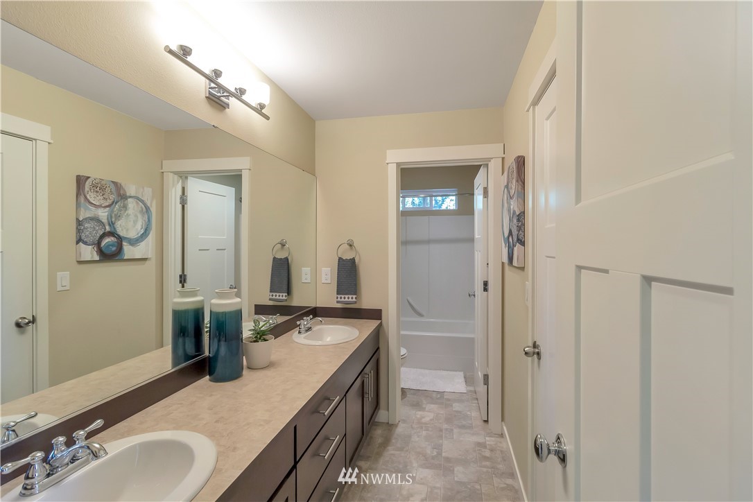 4431 225th Place Southeast Bothell, WA 98021 - Photo 10 of 19 a spacious bathroom with a granite countertop double vanity sink a mirror and a shower