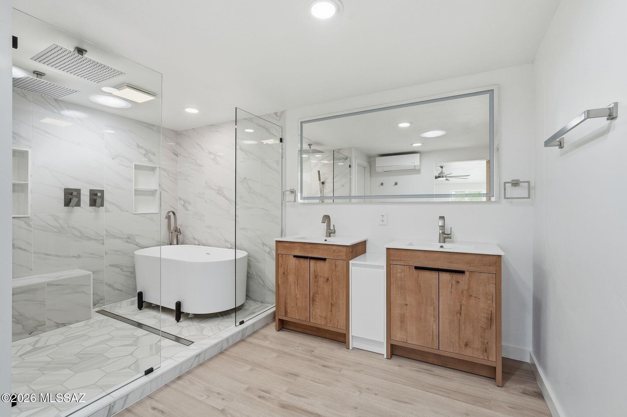 950 West Ina Road Tucson, AZ 85704 - Photo 19 of 54 a large bathroom with a granite countertop sink a toilet a mirror and bathtub
