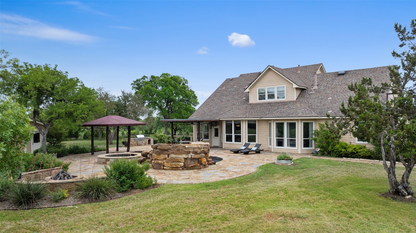 a front view of a house with garden and trees
