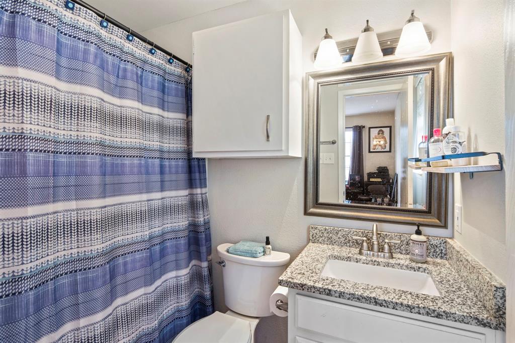 2102 Kenneth Avenue, Unit A Austin, TX 78741 - Photo 7 of 15 Bathroom vanity featuring a polished granite countertop, undermount sink, and brushed nickel faucet