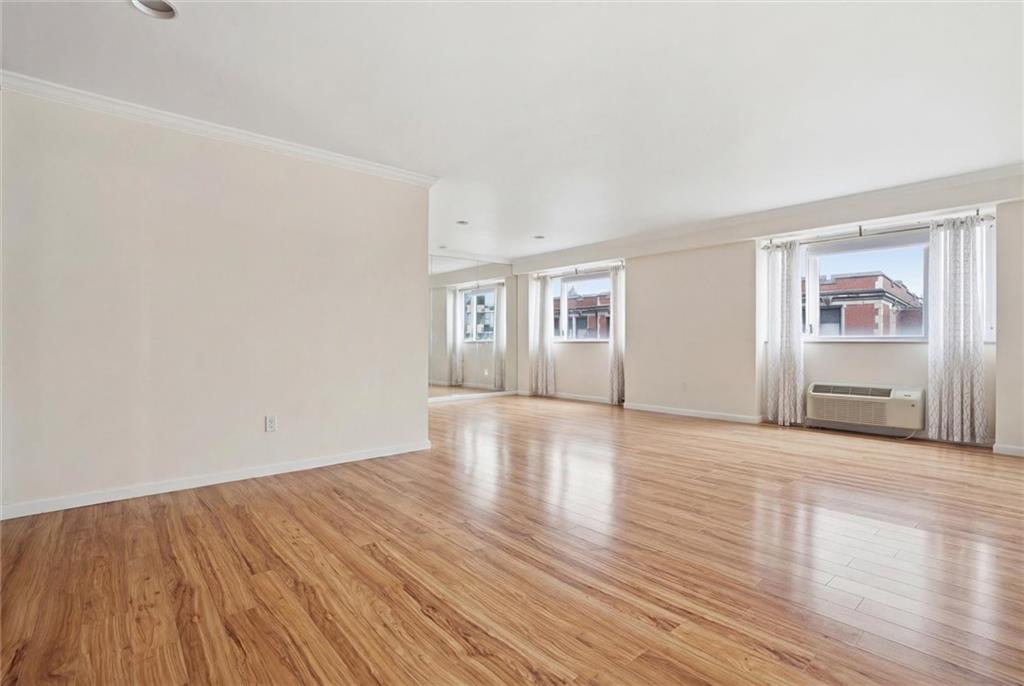 128 North Craig Street, Unit 511 Pittsburgh, PA 15213 - Photo 11 of 46 a view of an empty room with wooden floor and a window