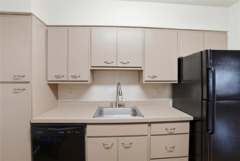 128 North Craig Street, Unit 511 Pittsburgh, PA 15213 - Photo 20 of 46 a kitchen with a sink cabinets and stainless steel appliances