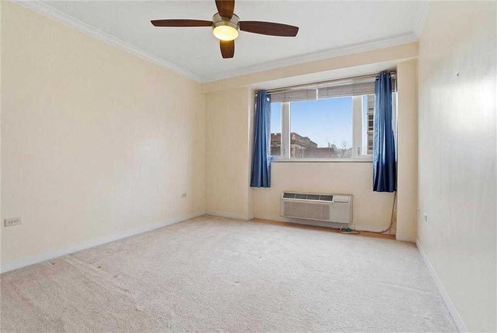 128 North Craig Street, Unit 511 Pittsburgh, PA 15213 - Photo 23 of 46 an empty room with a ceiling fan and windows