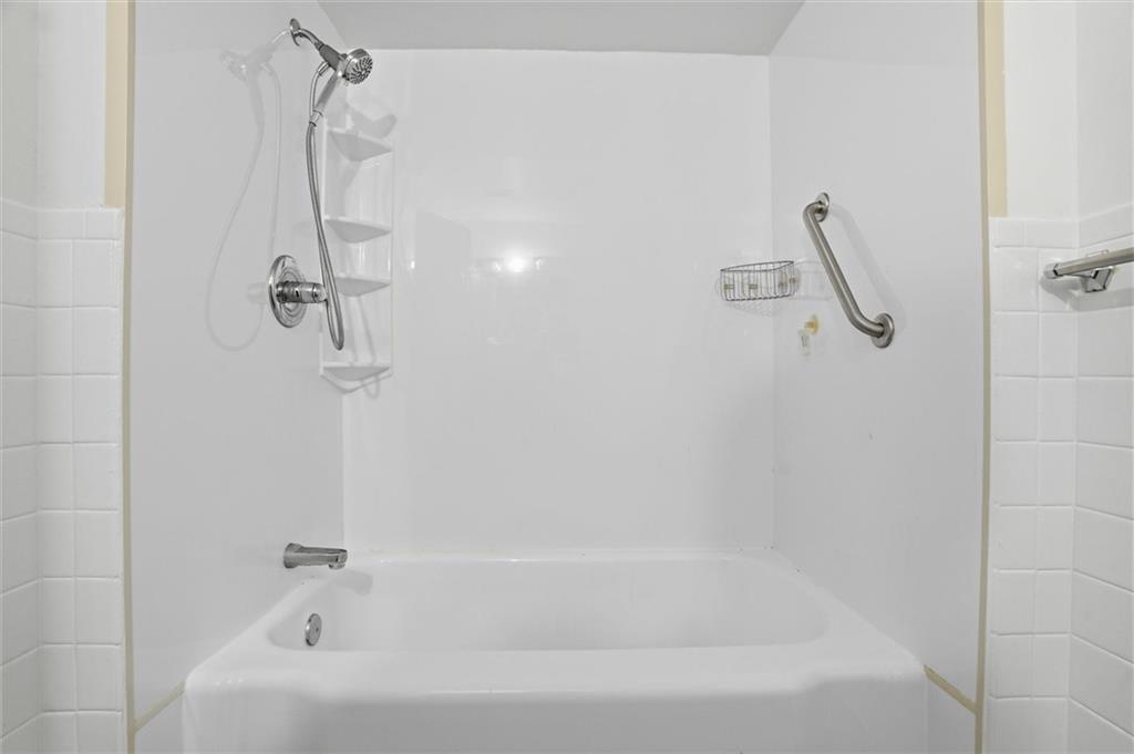 128 North Craig Street, Unit 511 Pittsburgh, PA 15213 - Photo 33 of 46 a bathroom with a bath tub with a shower