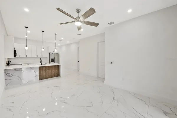 a large white kitchen with a large window