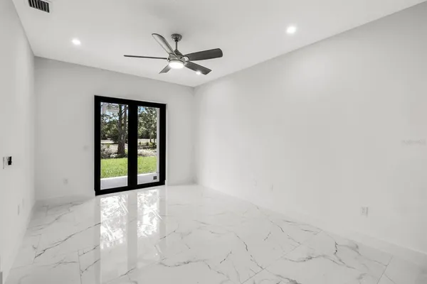 an empty room with windows and closet