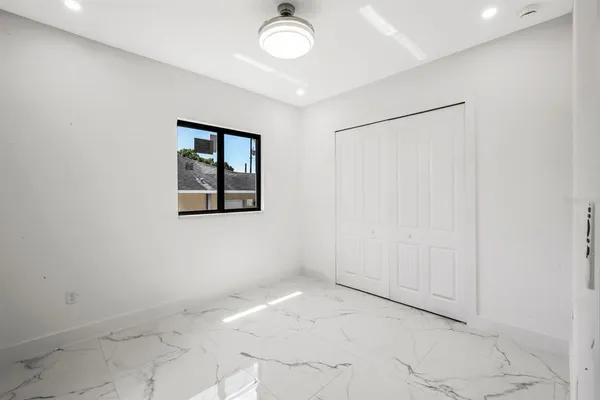 a bathroom with a sink a toilet a mirror and shower