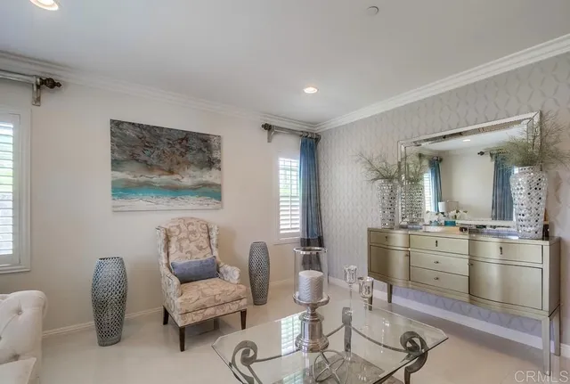 a living room with furniture and a kitchen