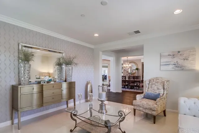 a living room with furniture and a view of kitchen