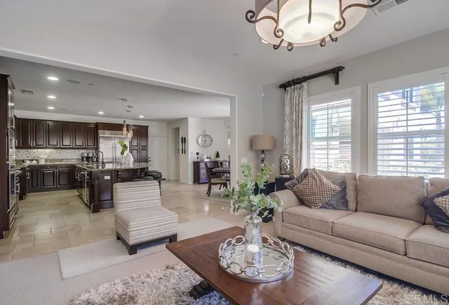 a living room with furniture chandelier and a table
