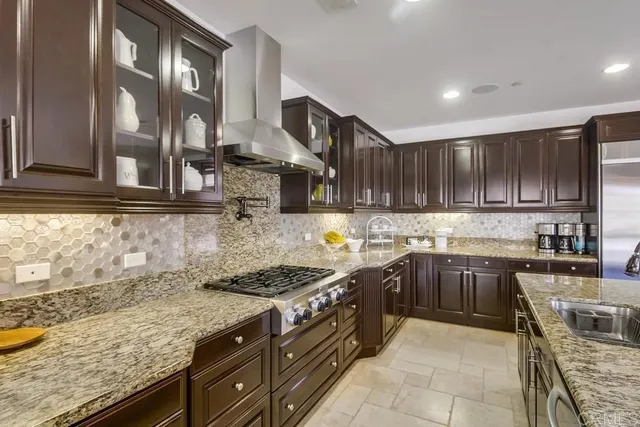 a kitchen with granite countertop a sink stove and cabinets