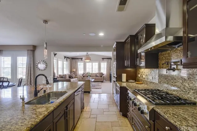 a kitchen with stainless steel appliances granite countertop a sink counter space cabinets and a counter top space