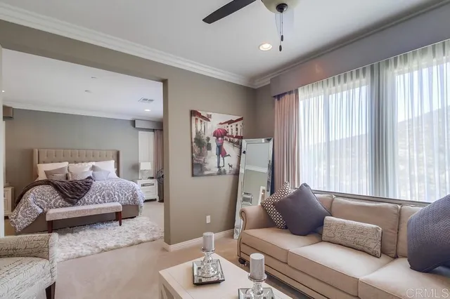 a large bed sitting in a bedroom next to a window