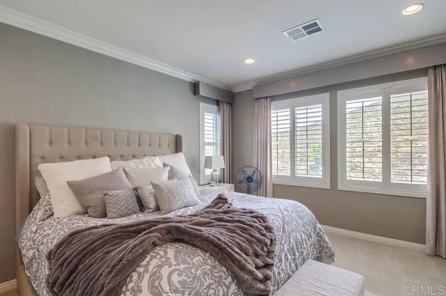 a bedroom with a bed and flat screen tv