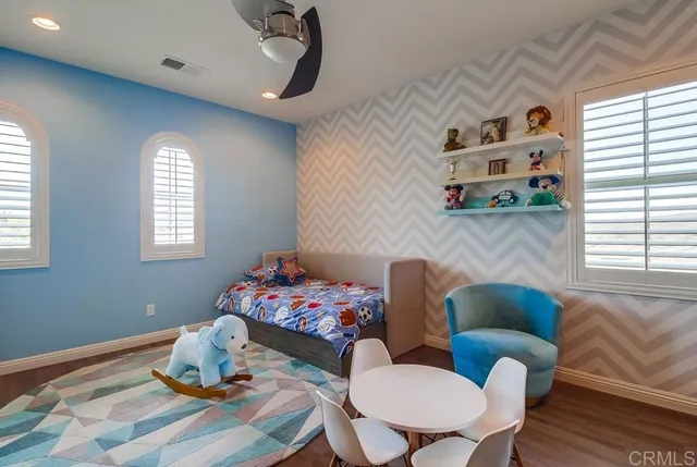 a bedroom with a bed and a table in it