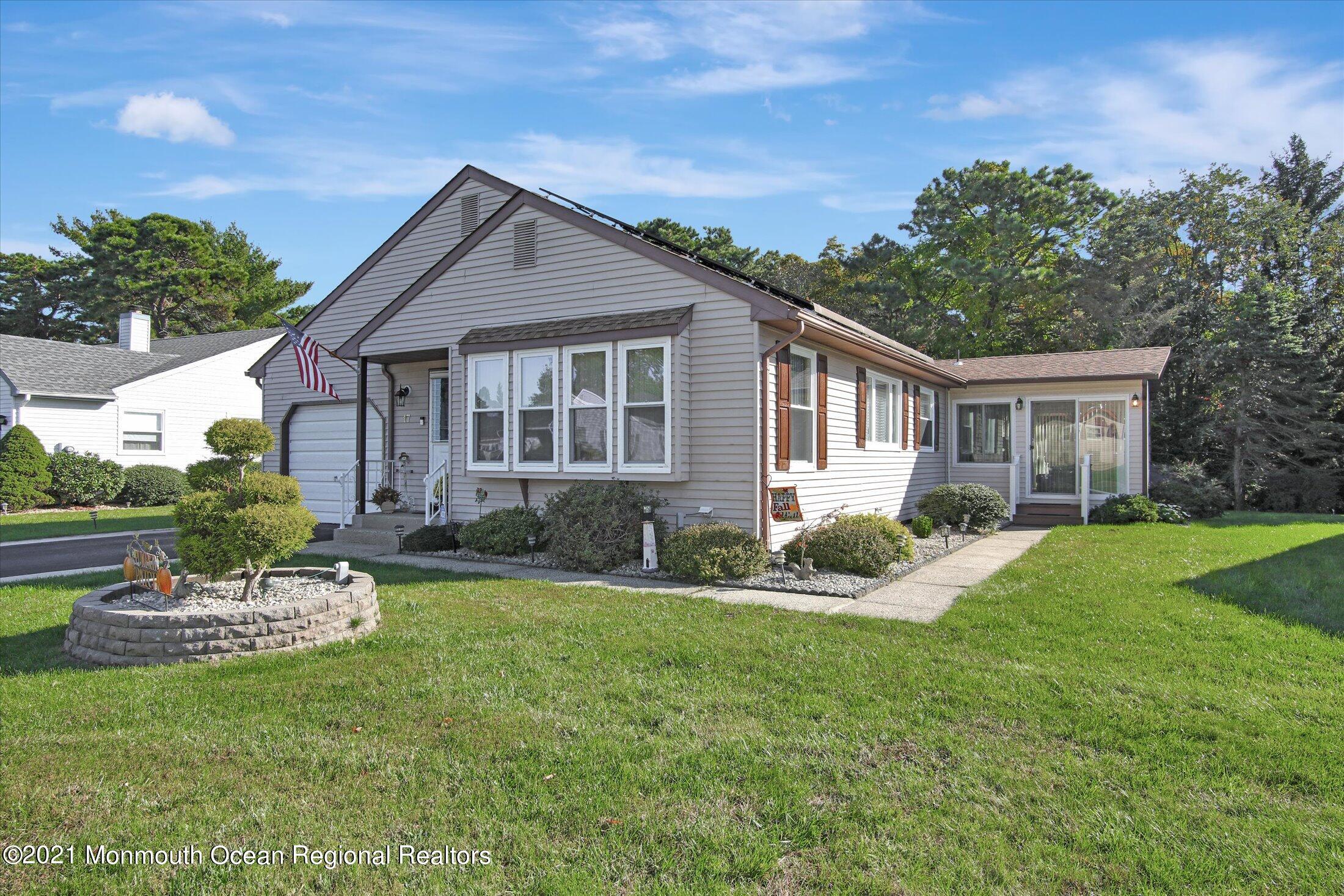 a front view of house with yard and green space
