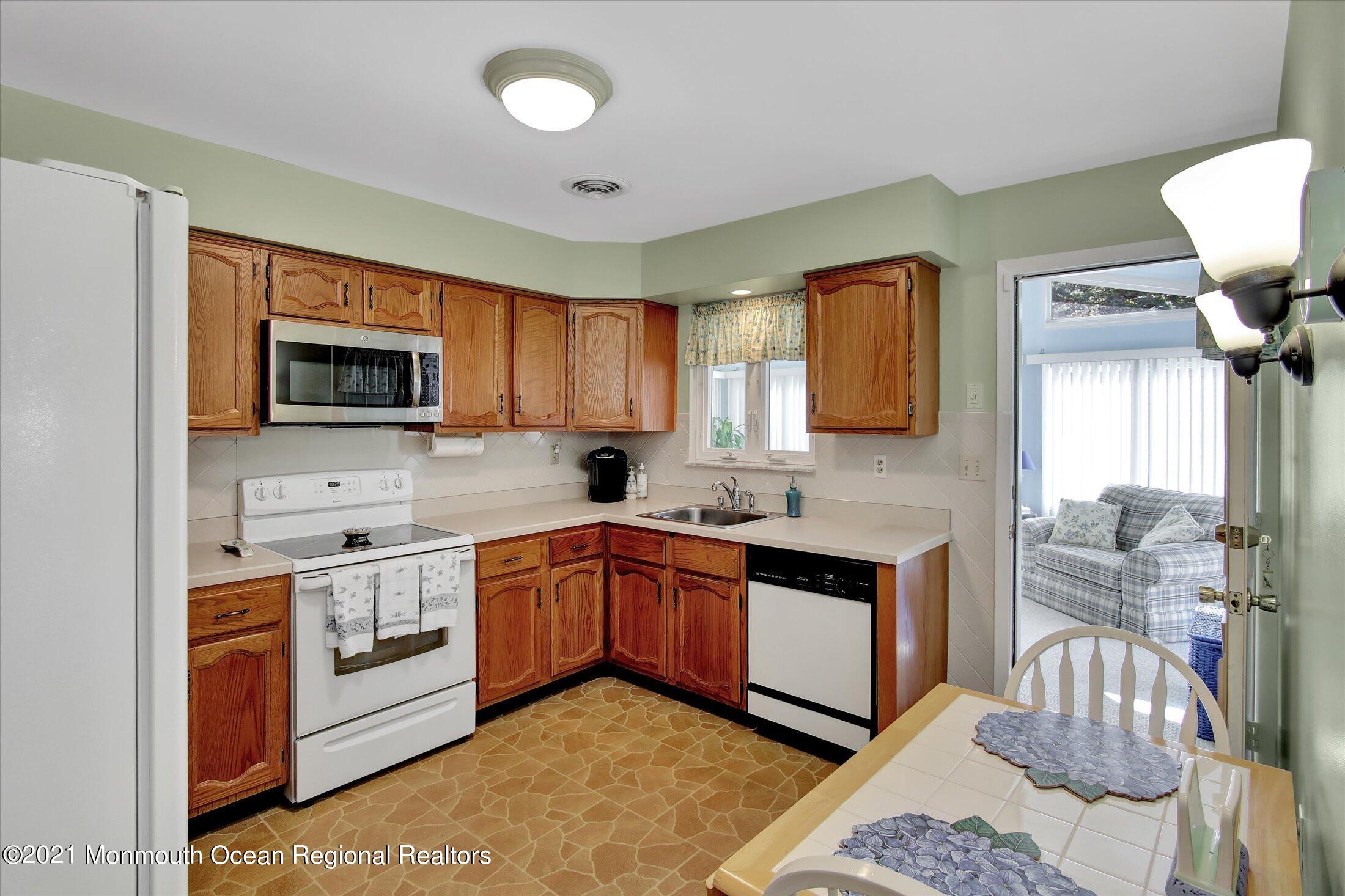 17 Ashley Road Whiting, NJ 08759 - Photo 14 of 31 a kitchen with stainless steel appliances granite countertop a stove a sink and a microwave