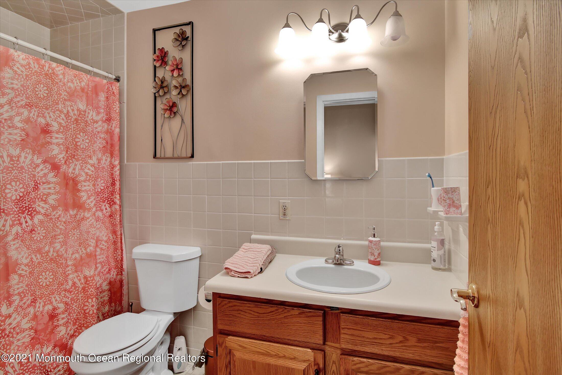 17 Ashley Road Whiting, NJ 08759 - Photo 24 of 31 a bathroom with a toilet sink and mirror